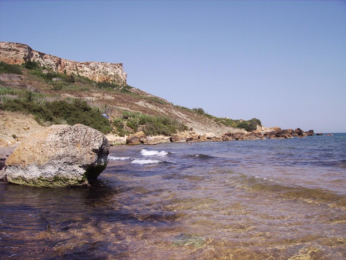 The secluded sandy cove of San Blas Bay near Nadur